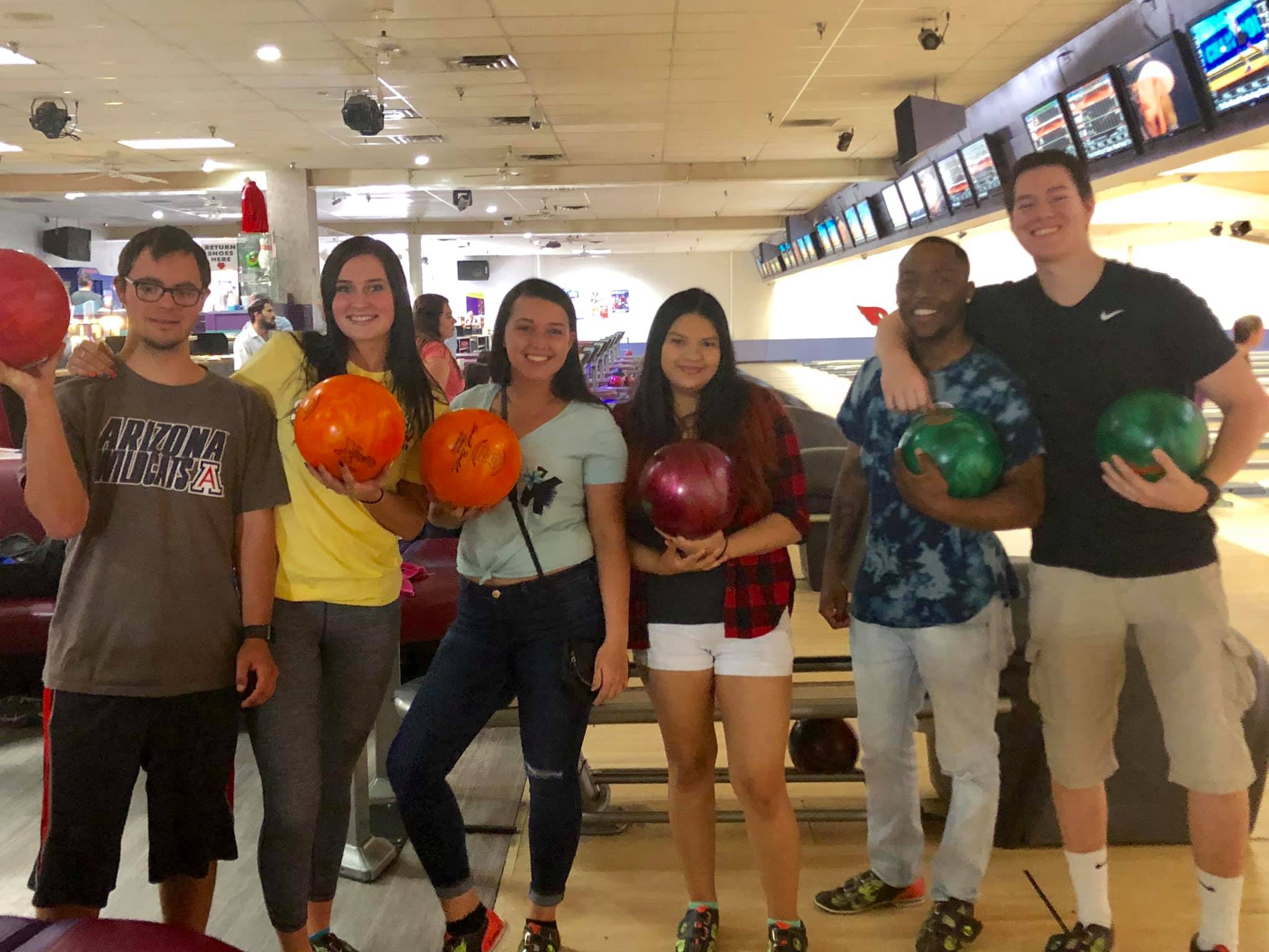 group of students posing in bowling alley
