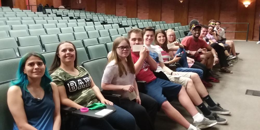 group of students seated in auditorium for graduation practice