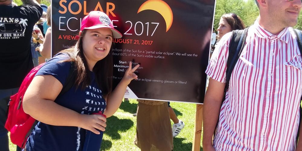 female student and male peer mentor attending 2017 solar eclipse event on campus mall
