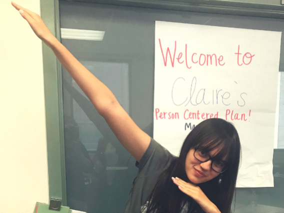 female student dabbing in front of her PCP poster